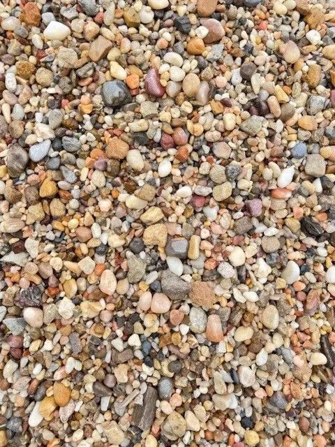 Close-up of small multicolored pebbles and gravel covering the ground.