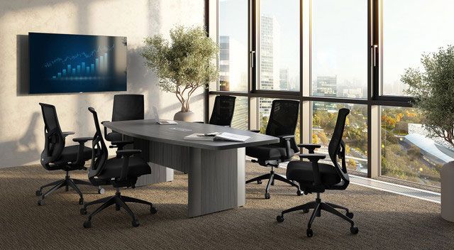 Conference room with large windows, a table, chairs, a TV screen, and a cityscape view.