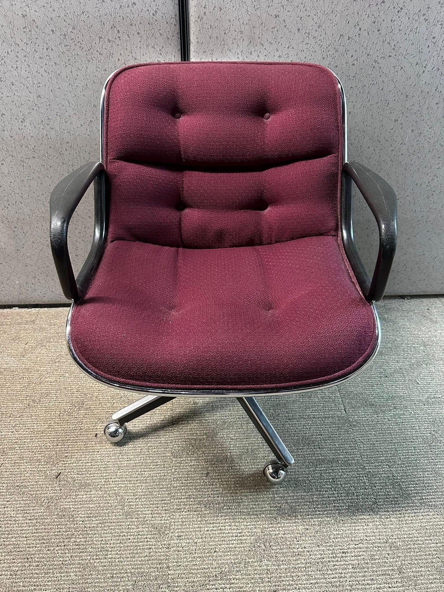 Office chair with maroon fabric and chrome base.