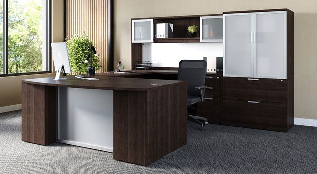 Dark wood executive office desk with white accents, with a hutch, and a tall cabinet; a chair is at the desk.