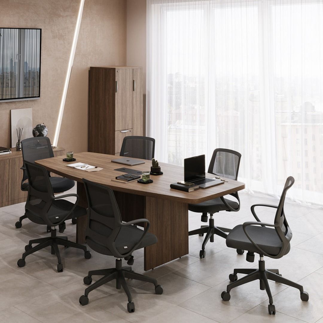 Conference room: large wooden table with six black mesh office chairs, cabinet, window.