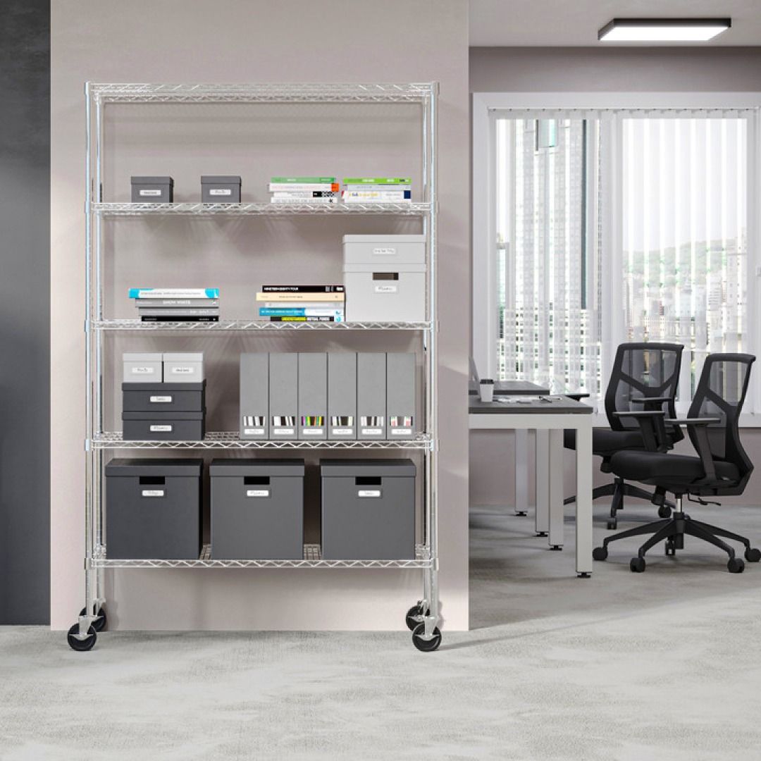 Metal shelving unit with storage boxes and office supplies. The background shows an office desk and chairs.