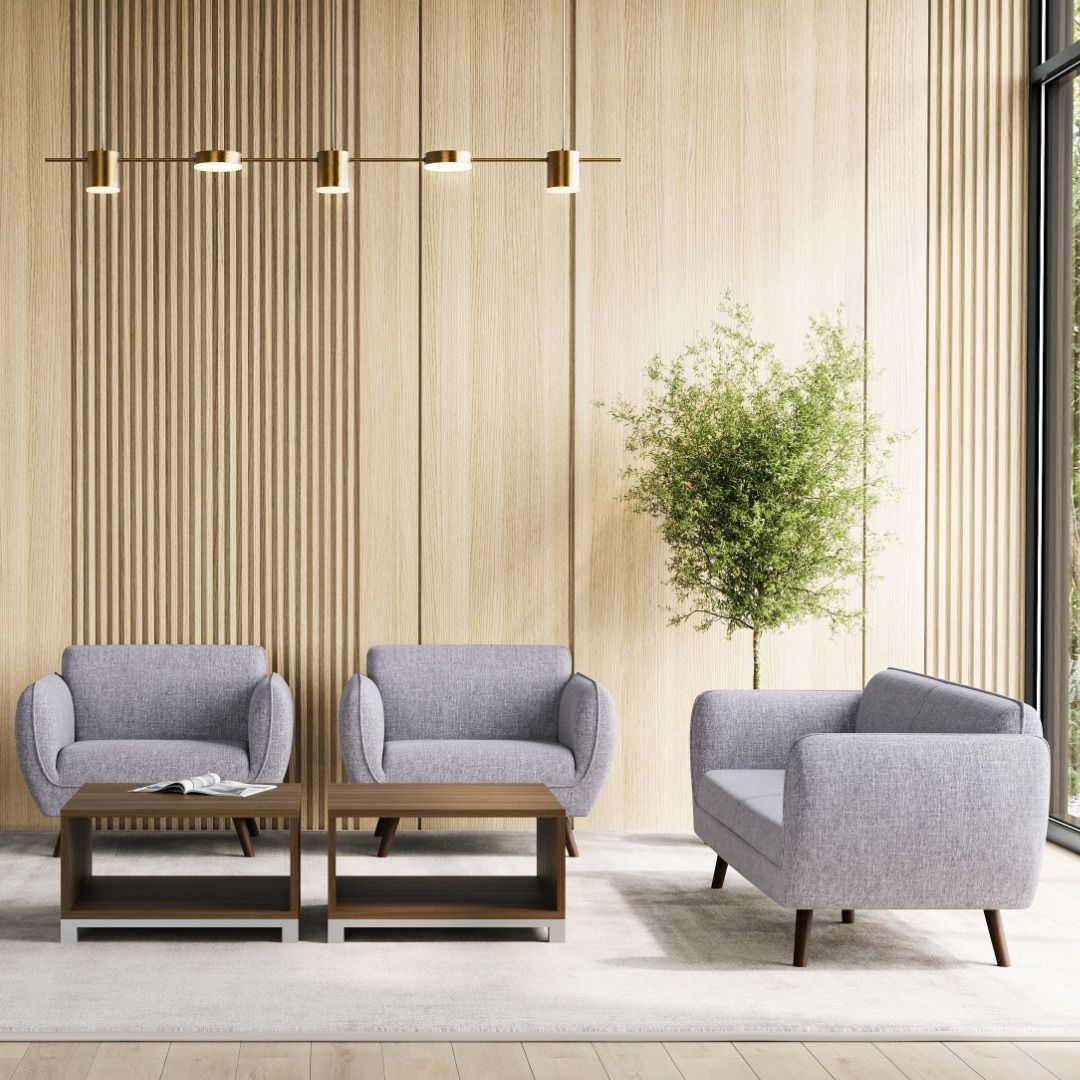 Three gray upholstered chairs and two brown square tables in a modern wooden room.
