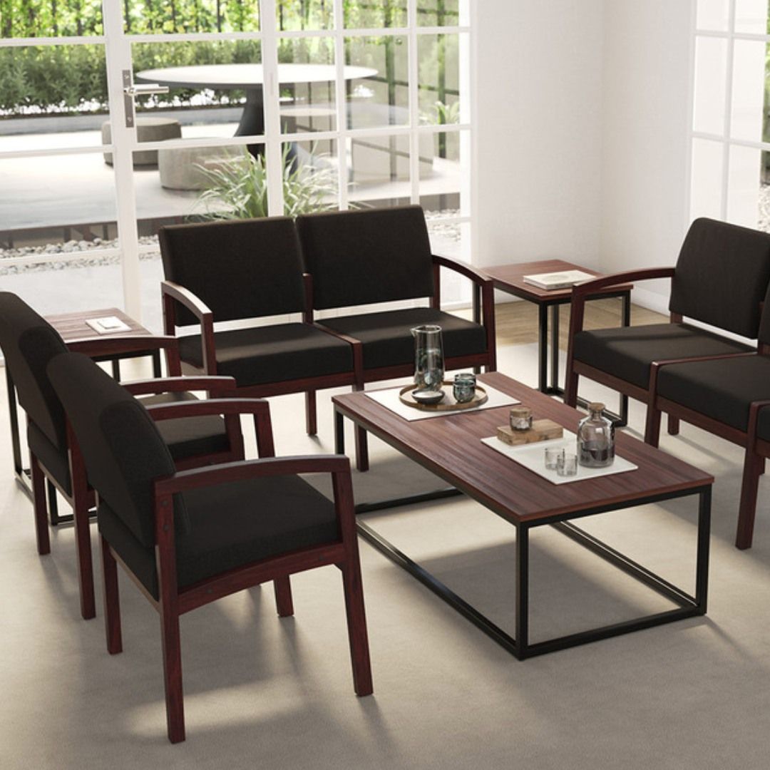 Living room with dark furniture, a coffee table, and large windows overlooking a patio.