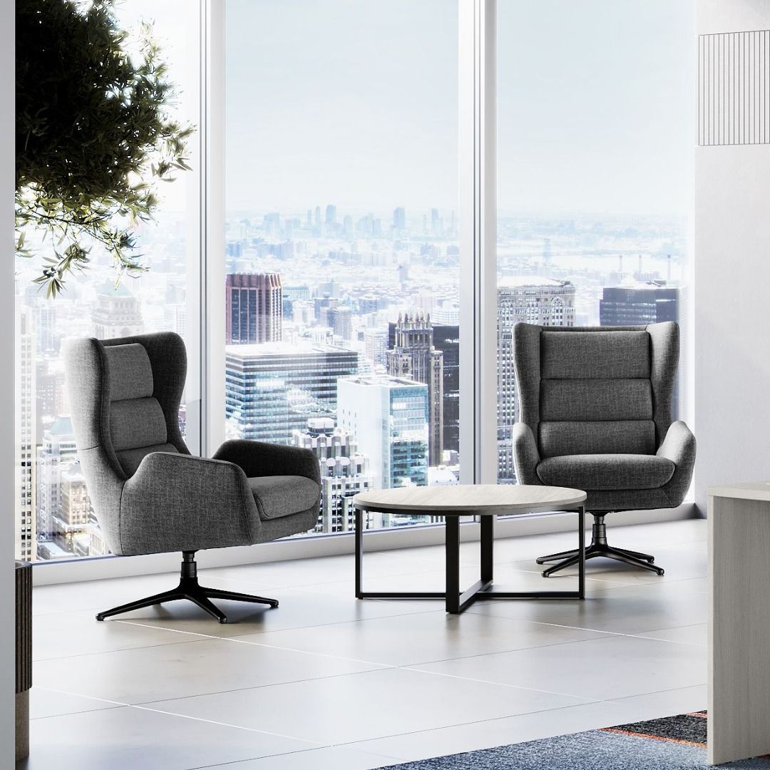 Two gray armchairs and a small table sit before a cityscape view in a modern room.