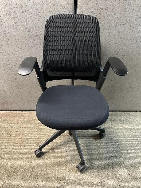 Black office chair with mesh back, padded seat, and adjustable armrests.