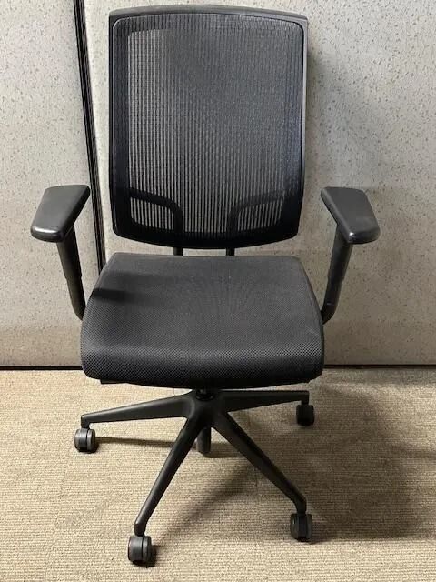 Black office chair with mesh back, padded seat and armrests, on a wheeled base.