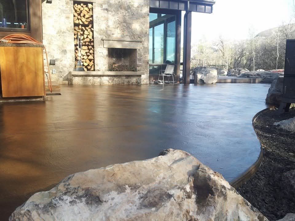 A large rock sits in front of a fireplace in a house