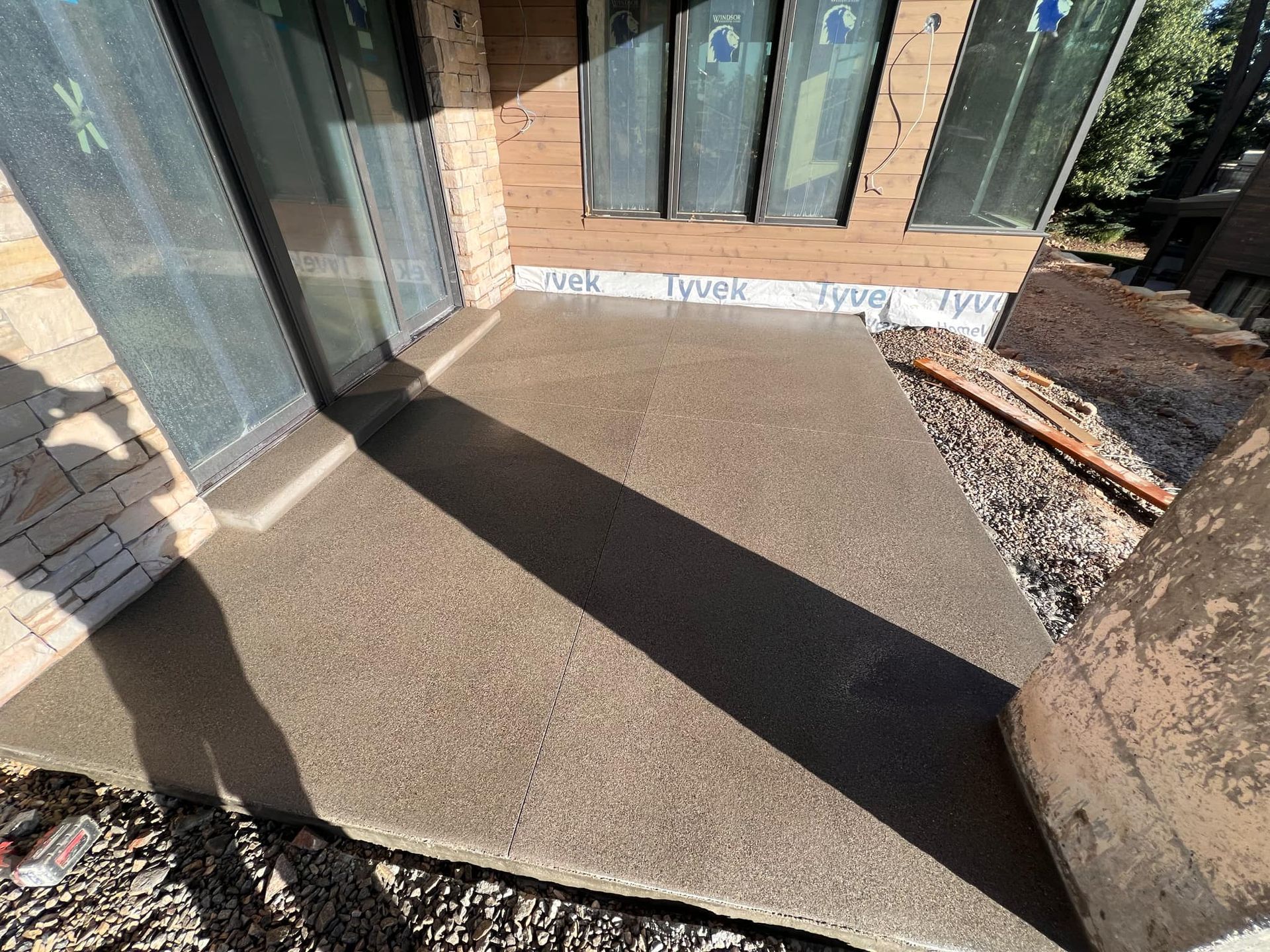 A concrete walkway is being built in front of a house.