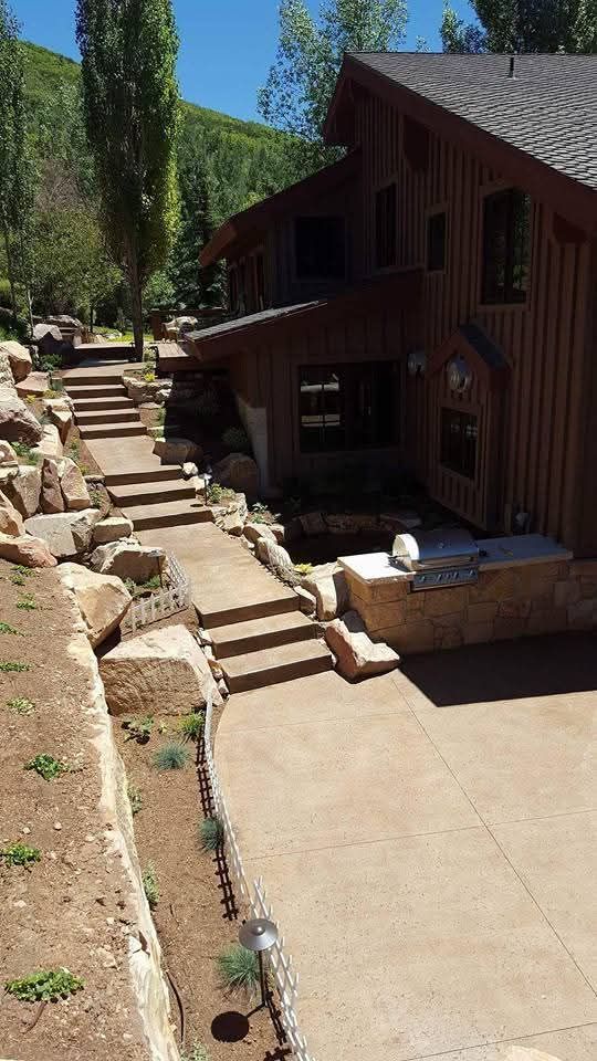 A large wooden house with stairs leading up to it.