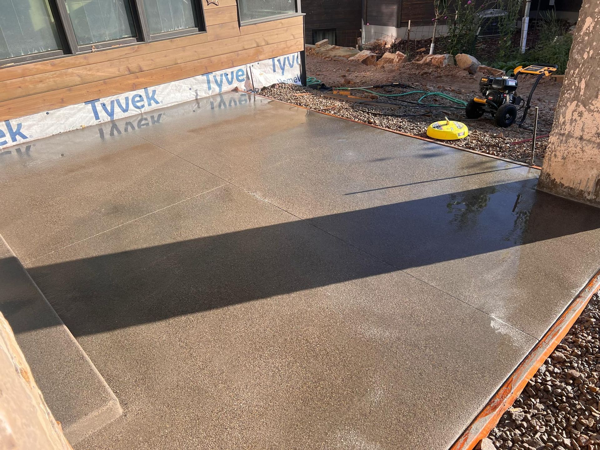 A concrete driveway is being built in front of a building.