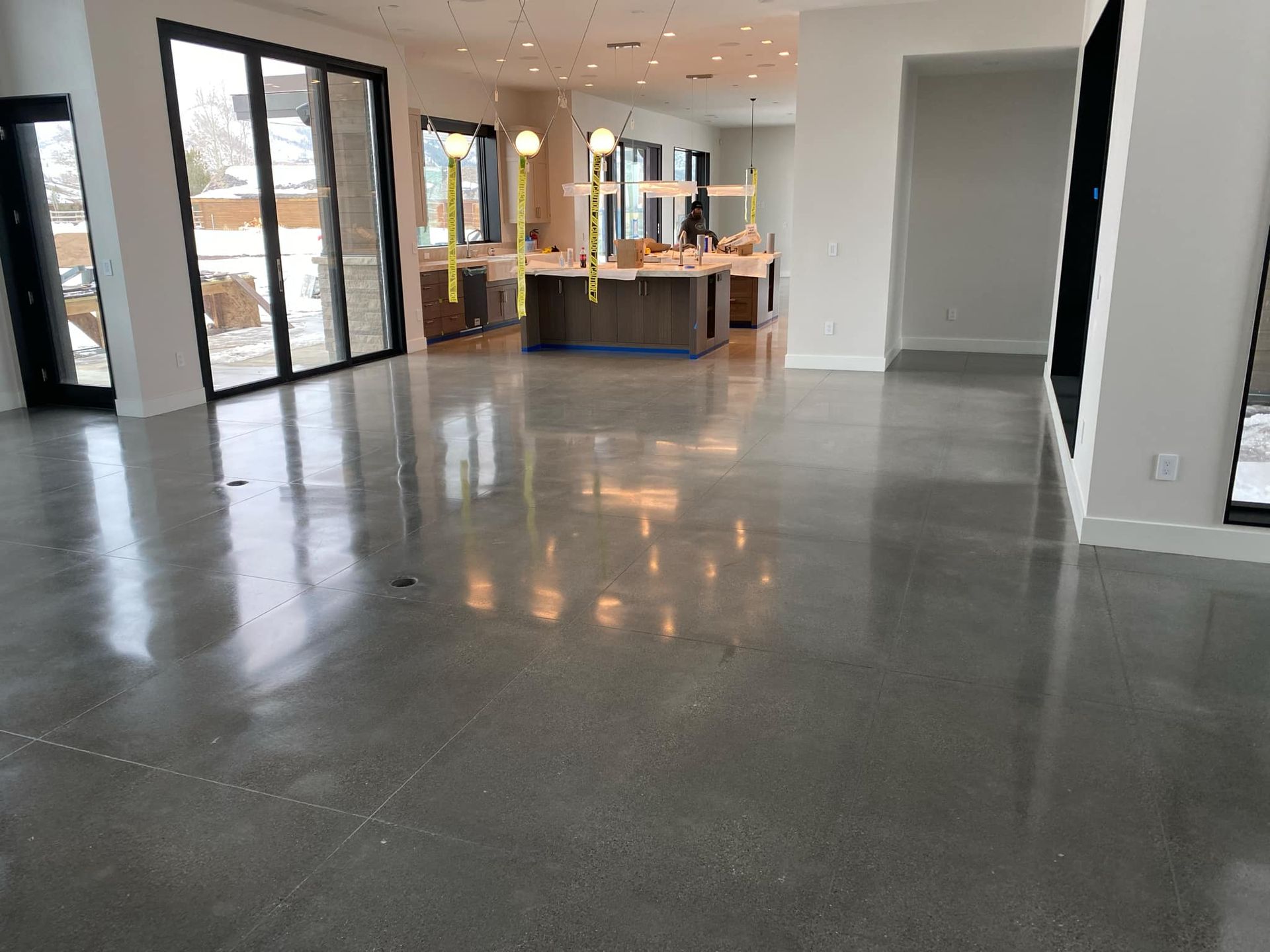 A large room with a shiny concrete floor and lots of windows.