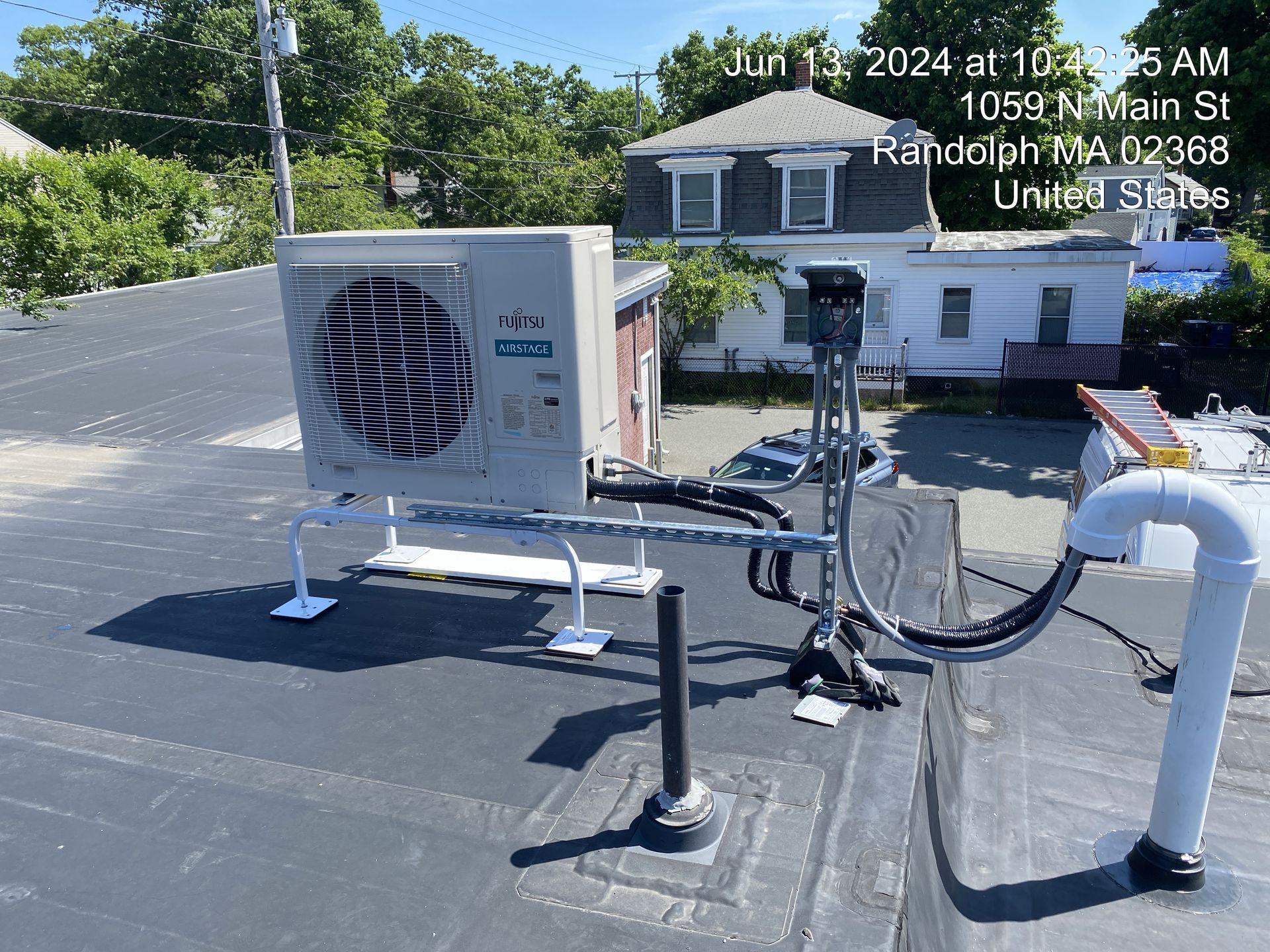 HVAC unit on a rooftop in Randolph, MA, on a sunny day.