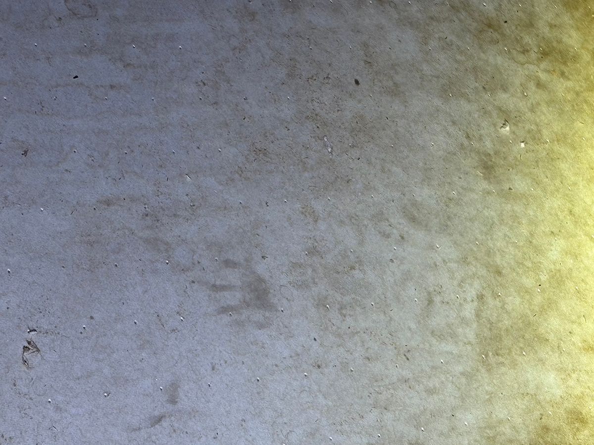 Gray concrete surface with a yellowish light glow on the right edge
