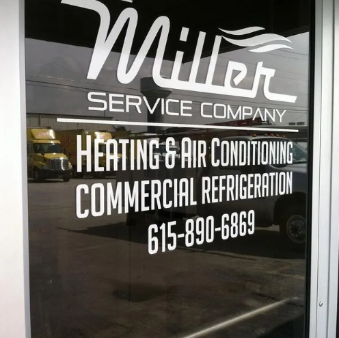 White decal on a glass door for Miller Service Company, including services and phone number 615-890-6869.