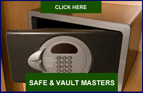 A safe with a green button that says safe & vault masters