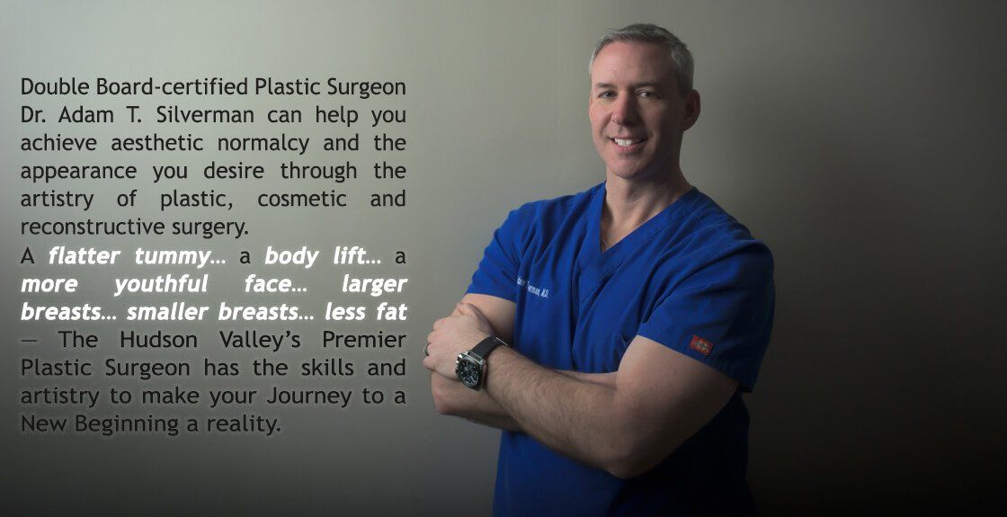 A man in a blue scrub top with his arms crossed