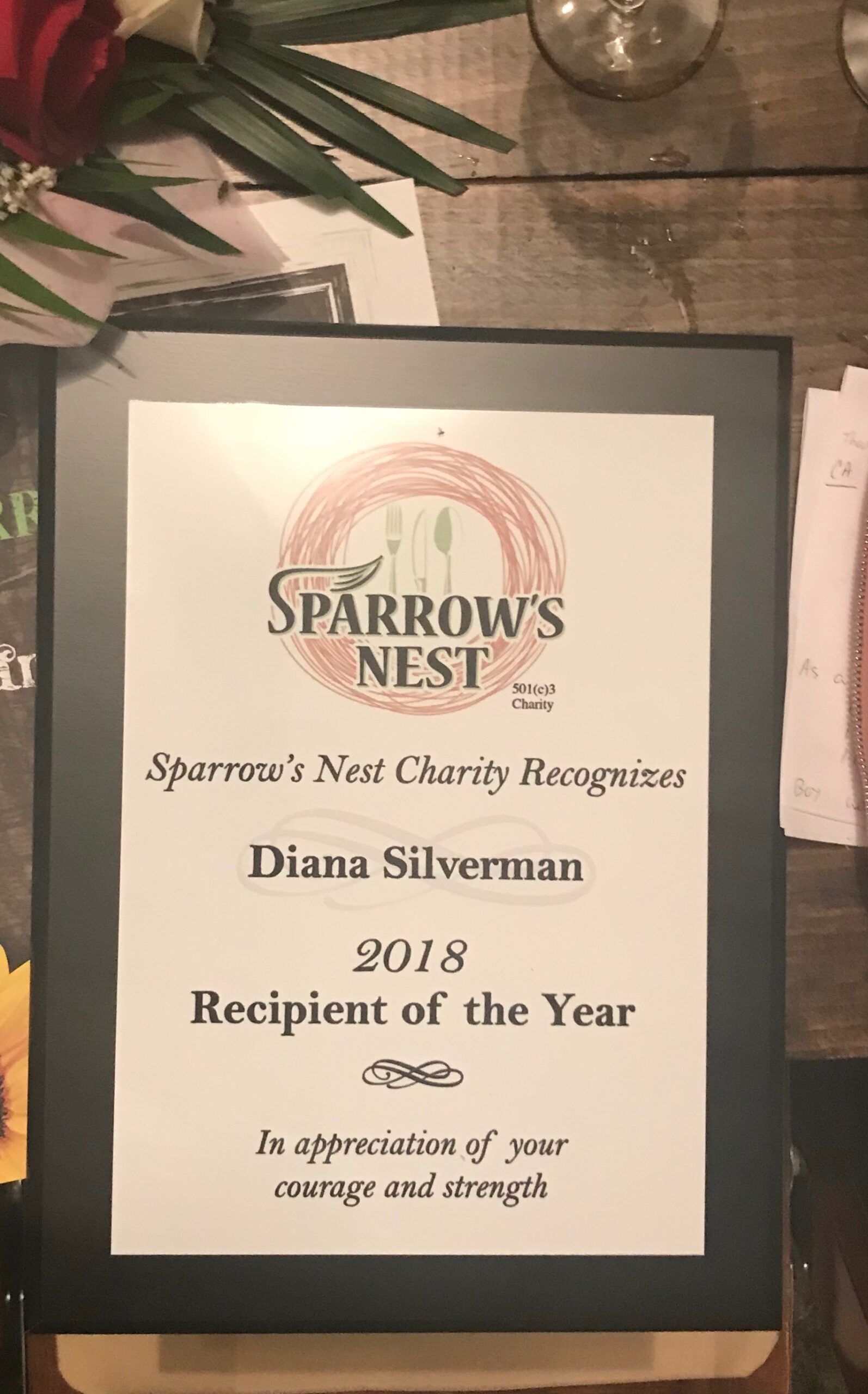 A framed certificate for sparrow 's nest charity recognizes diana silverman as recipient of the year.