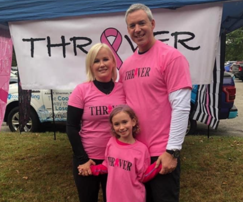 A family wearing pink shirts with the word thr on them