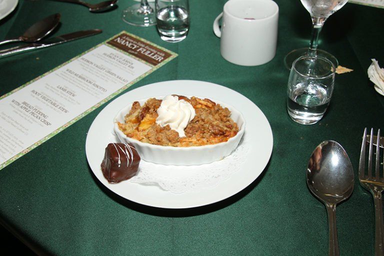 A plate of food on a table with a menu that says nancy potter