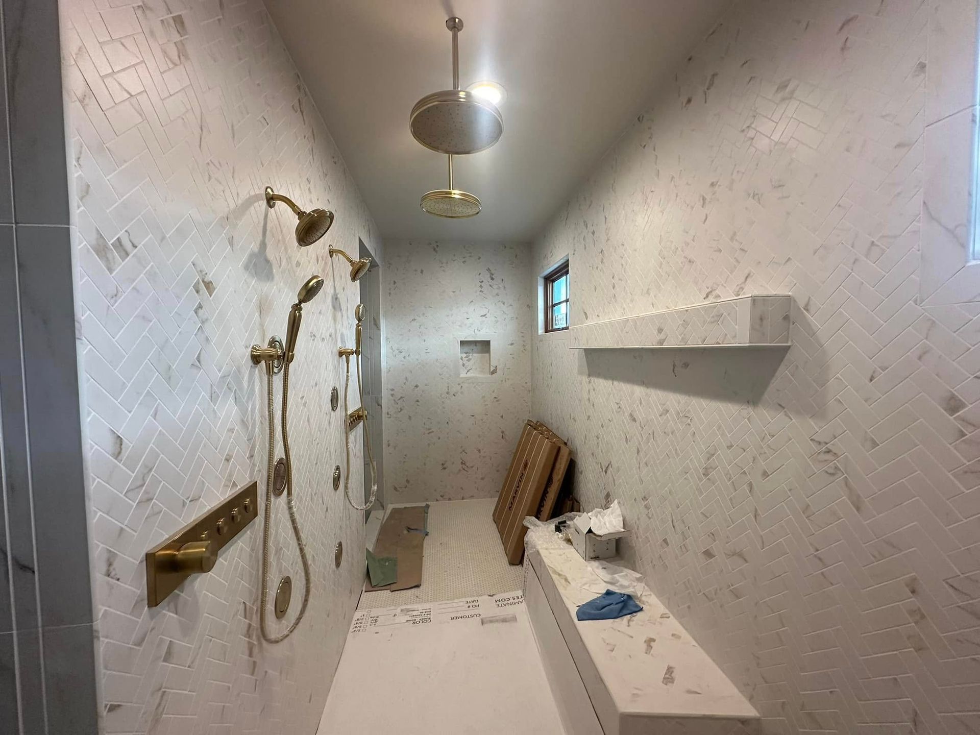 A bathroom with a bathtub , shower , and ceiling fan