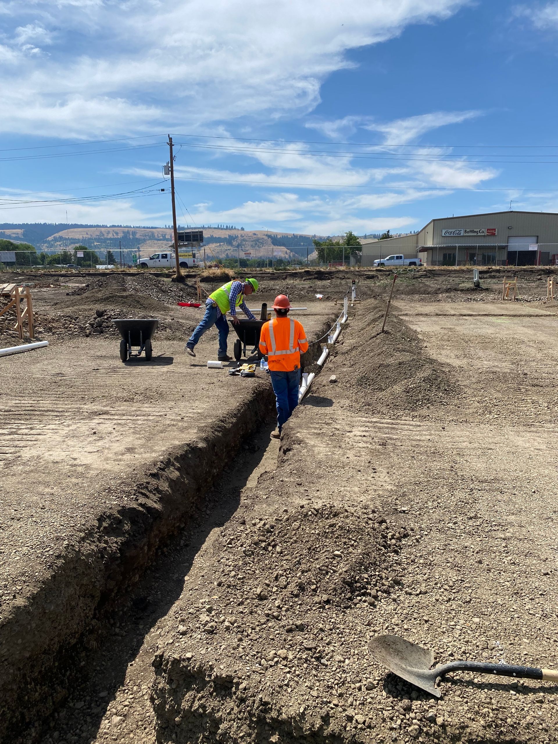 Workers digging a trench in a construction site.