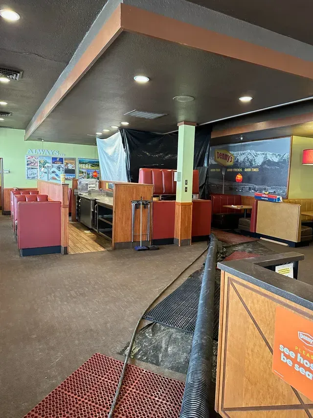 The inside of a restaurant with a sign that says no dogs allowed.