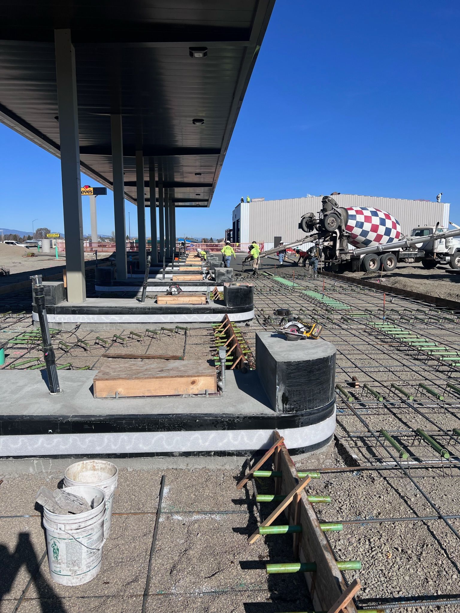 A construction site with a cement truck in the background
