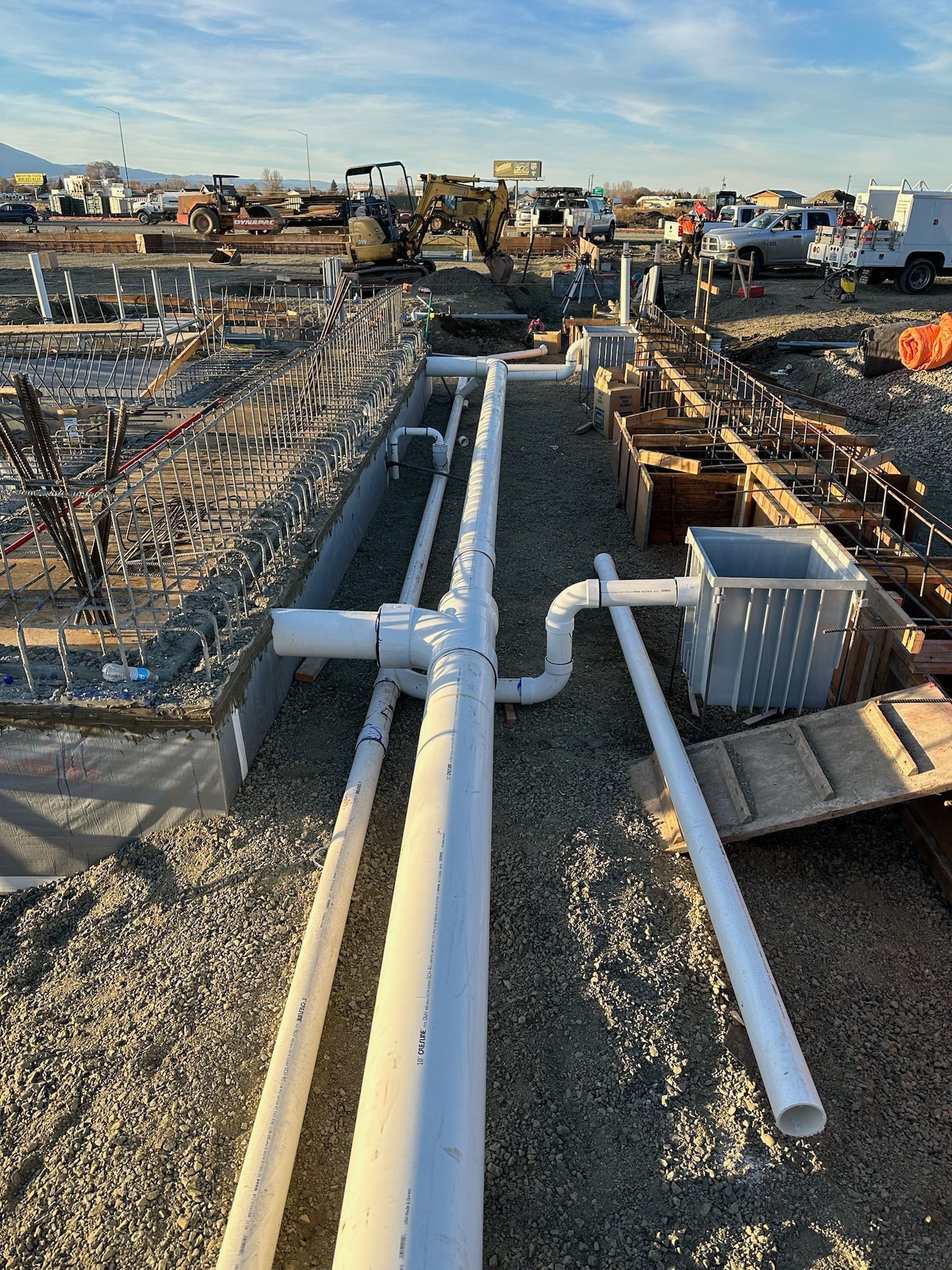 Plumbing pipes are being installed on a construction site