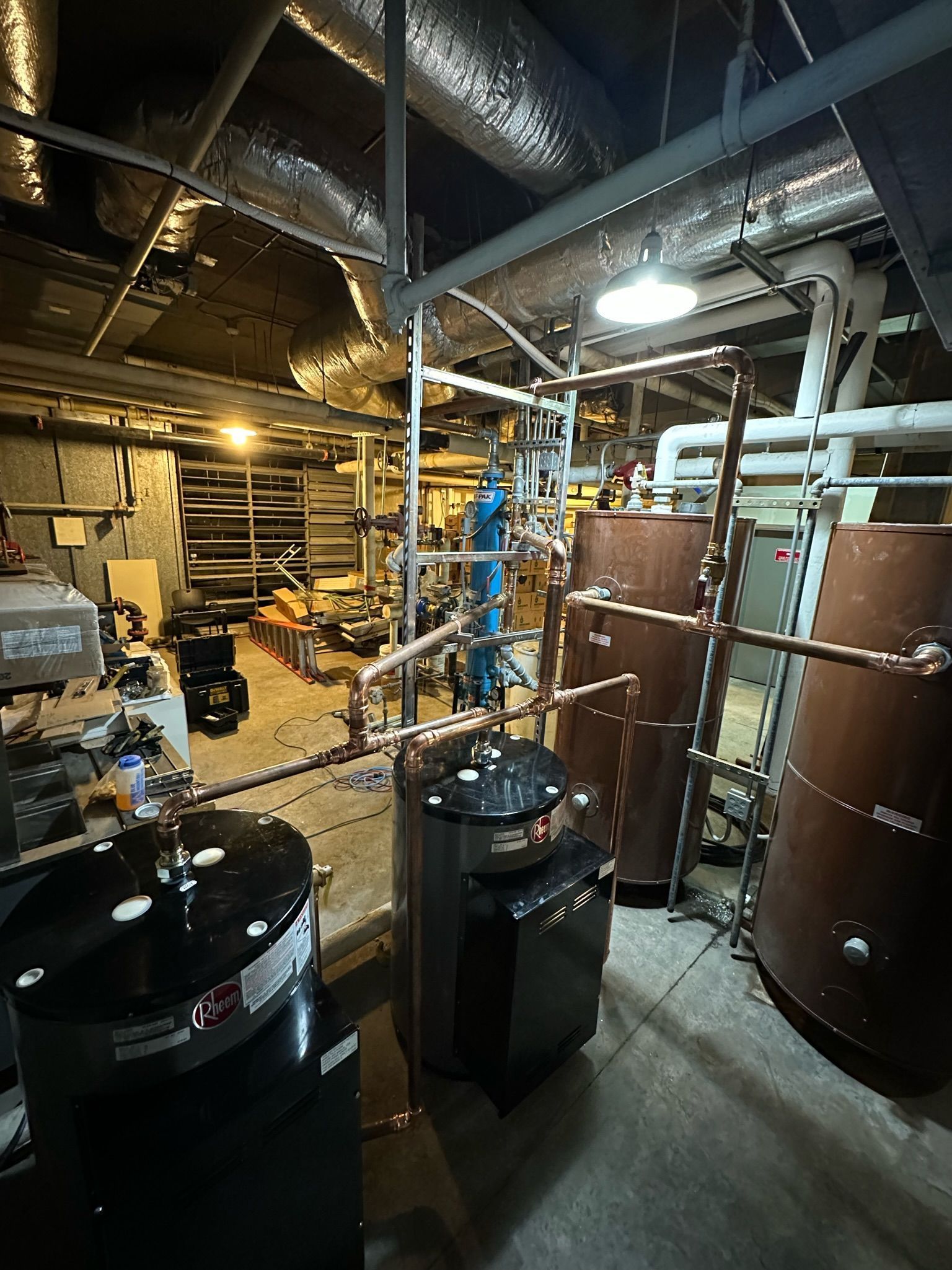 A room with a lot of pipes and tanks in it