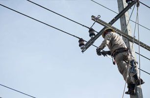 Learn More About Power & Commercial Utilities electrician on an electric post