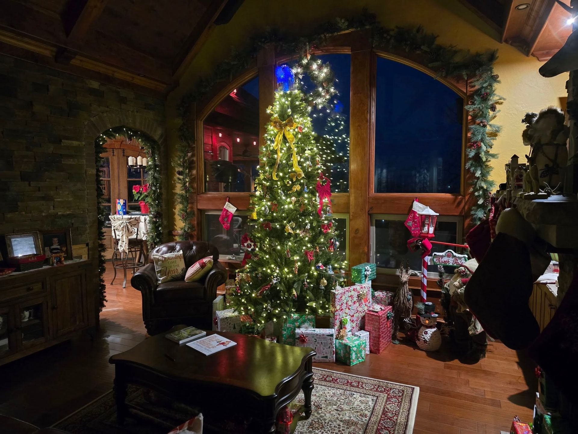Holiday home with Christmas lights and snow-covered roof in Southwest Missouri, symbolizing potentia