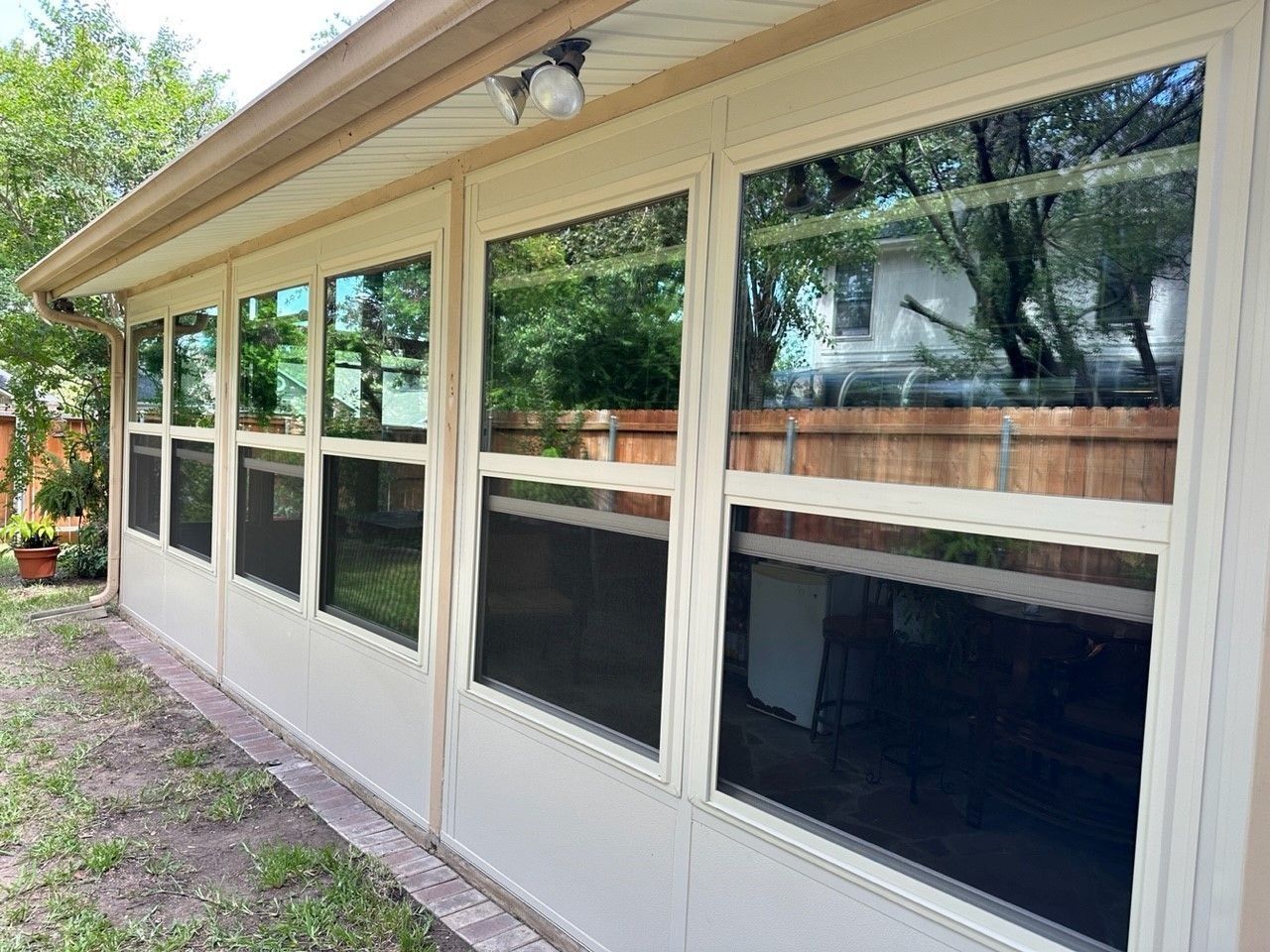 A house with a lot of windows on the side of it.