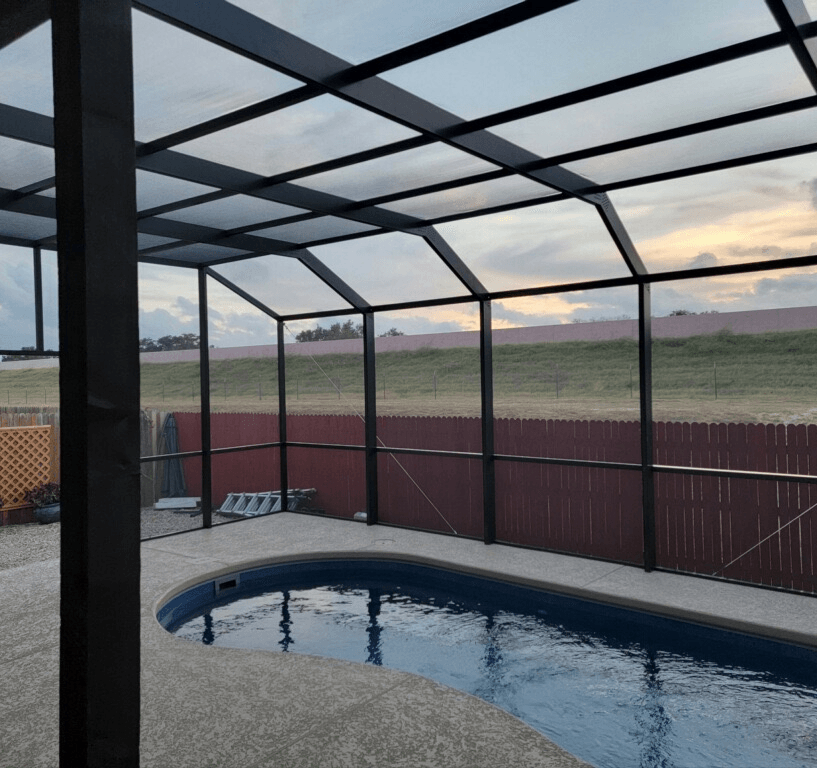 A screened in swimming pool with a clear roof