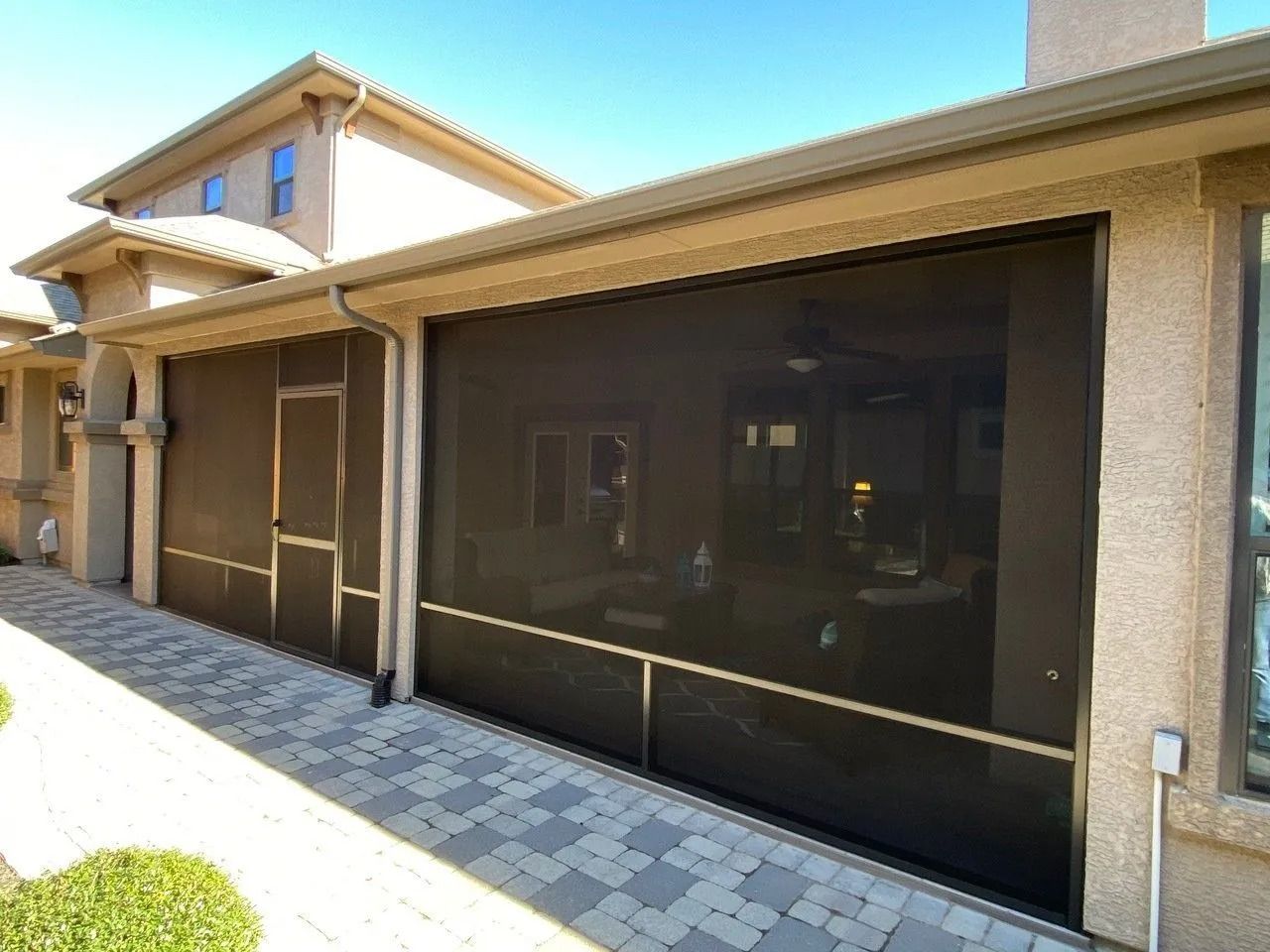 A house with a screen door on the side of it.