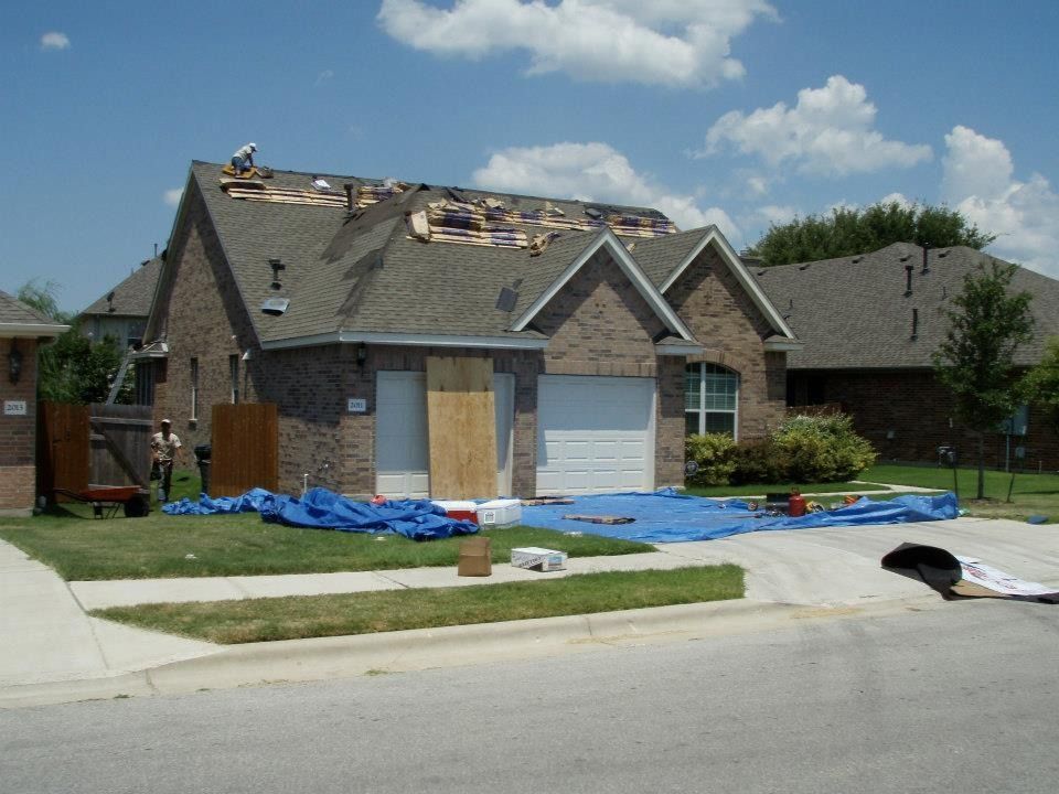 A house with a roof that is being repaired