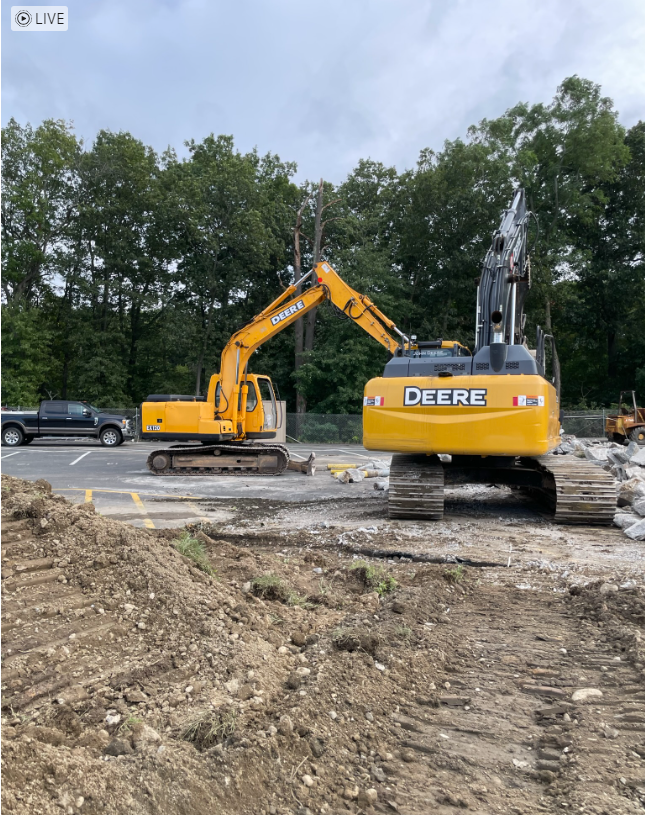 A deere excavator is working on a construction site