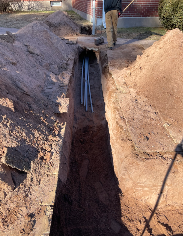 A man is digging a trench with a shovel