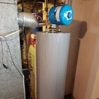 Water heater with blue expansion tank, installed in a basement.