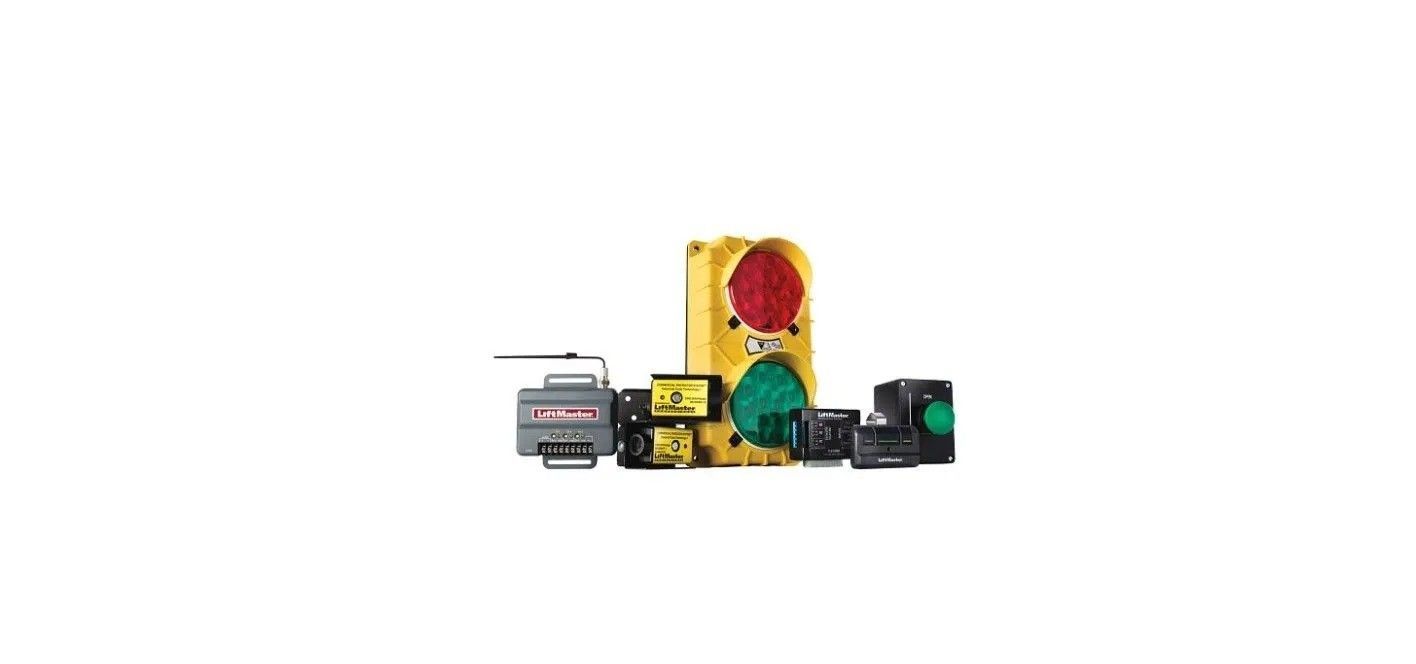Small assortment of electronic components and parts, including a red dome and green circuit board, on a white background