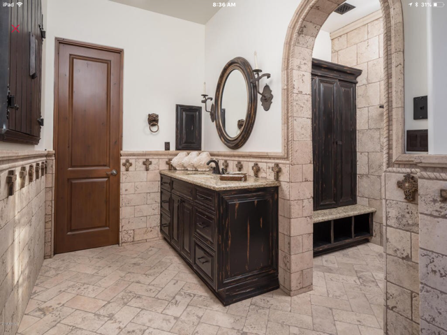 A bathroom with a sink, cabinets, and a mirror