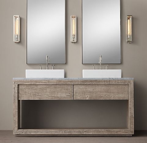 A bathroom with two sinks, cabinets, and two mirrors