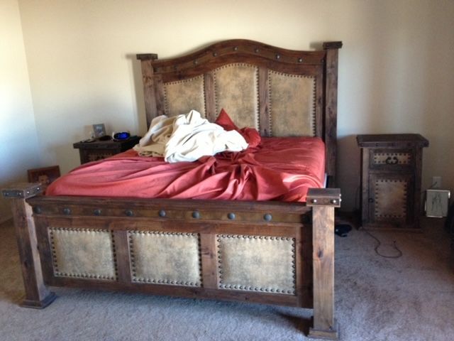 A bed with a red blanket on it in a bedroom