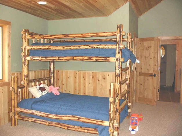 A bunk bed with a blue blanket in a room