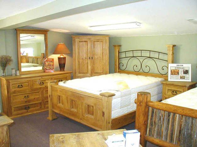 A bedroom with two beds a dresser and a mirror