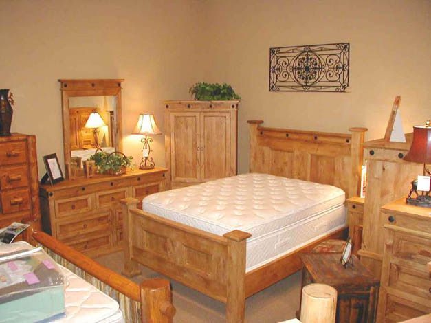 A bedroom with a bed dresser and mirror