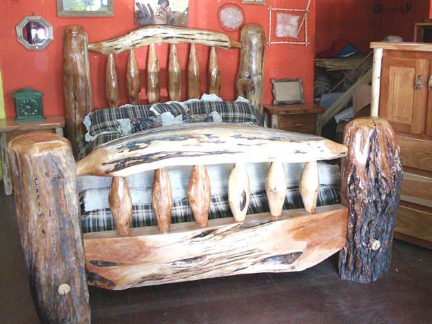 A bed made out of logs in a bedroom