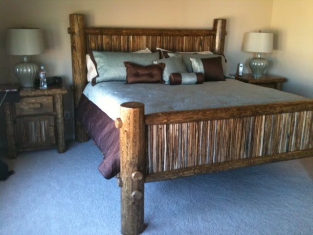 A bedroom with a wooden bed and two lamps