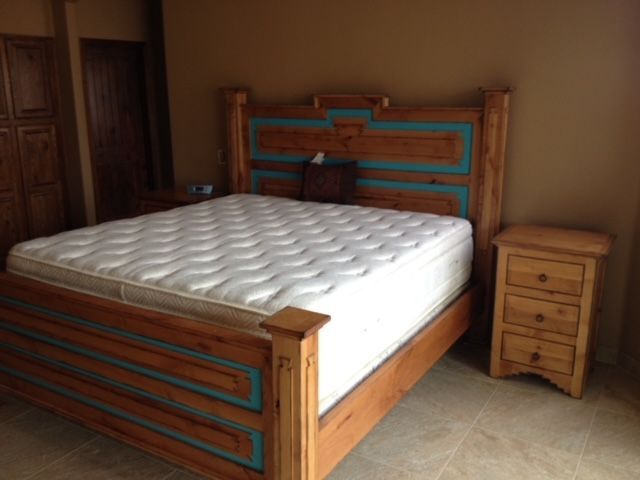 A bed with a mattress and a nightstand in a bedroom