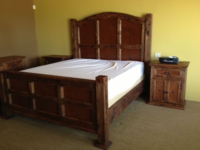 A bedroom with a wooden bed and two nightstands
